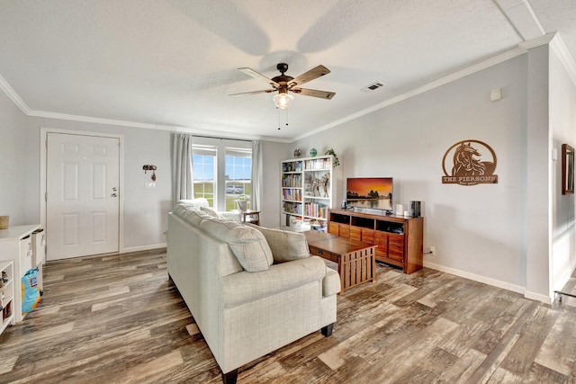 living room with wood-type flooring, a textured ceiling, ceiling fan, and crown molding