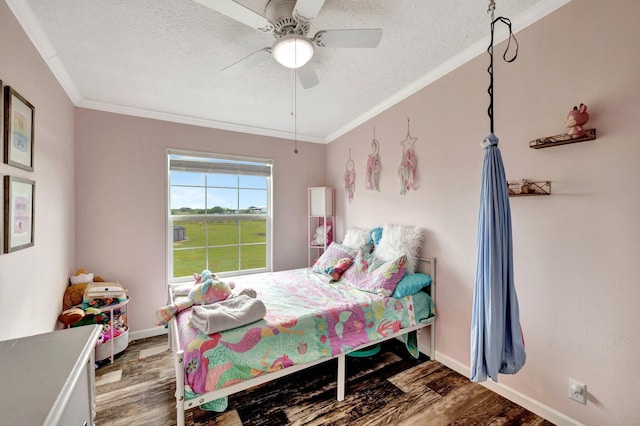 bedroom featuring hardwood / wood-style floors, ceiling fan, and crown molding