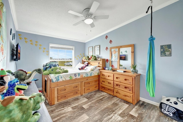 bedroom with a textured ceiling, ceiling fan, wood-type flooring, and crown molding