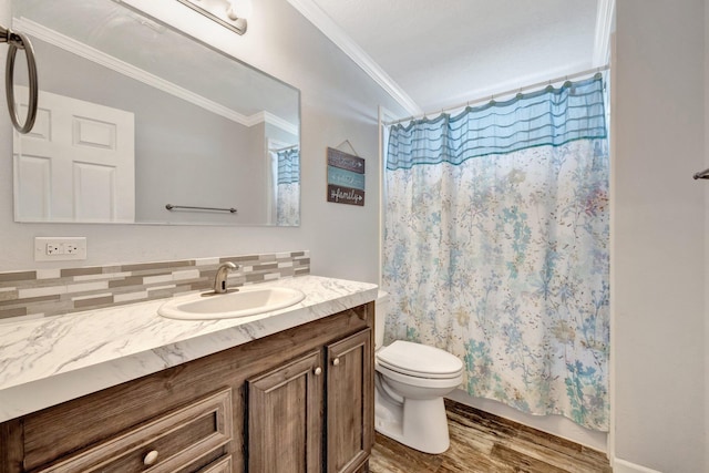 bathroom with backsplash, ornamental molding, vanity, hardwood / wood-style flooring, and toilet