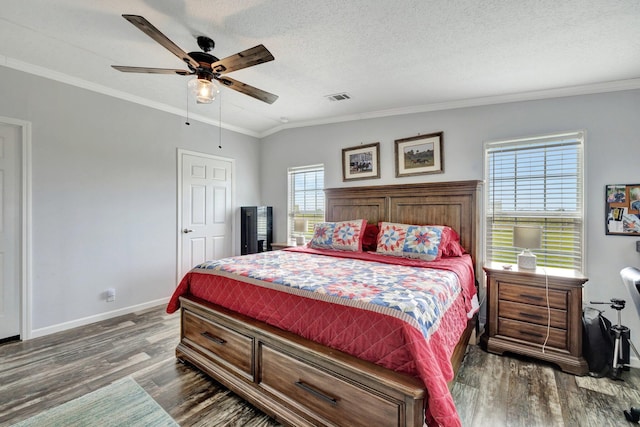 bedroom featuring ceiling fan, dark hardwood / wood-style flooring, ornamental molding, and a textured ceiling