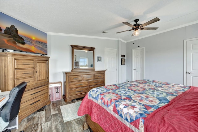 bedroom featuring ceiling fan, wood-type flooring, ornamental molding, and a textured ceiling