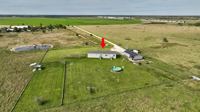 birds eye view of property with a rural view