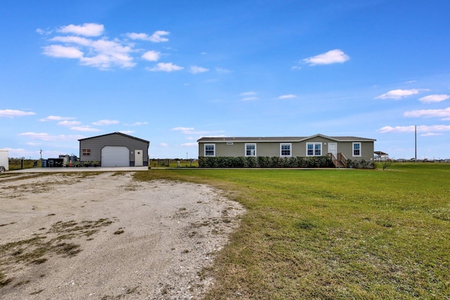 ranch-style home featuring an outbuilding, a front lawn, and a garage