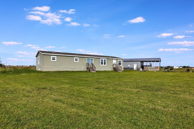 rear view of property with a lawn