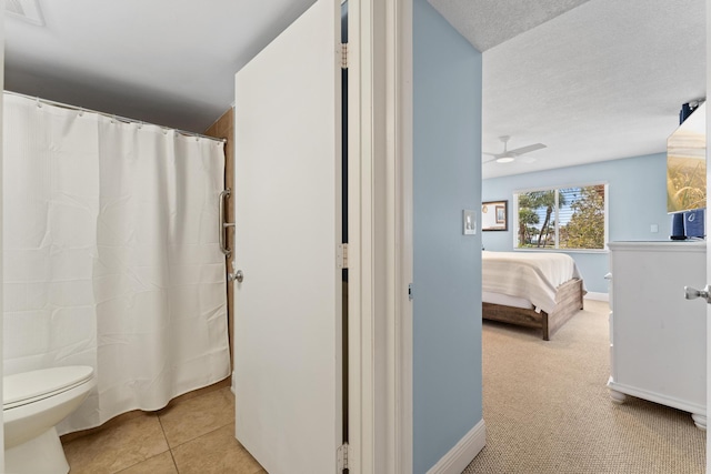 bathroom featuring tile patterned floors, toilet, and ceiling fan