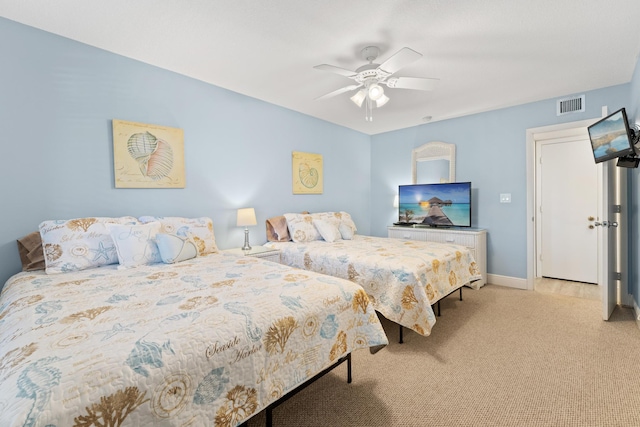 bedroom with ceiling fan and light carpet