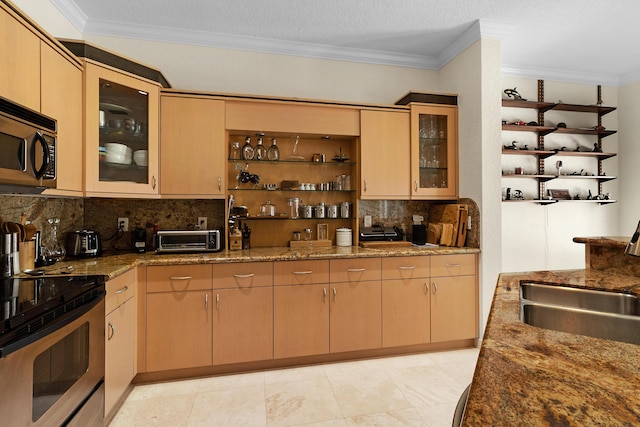 kitchen featuring stainless steel appliances, sink, light brown cabinetry, and decorative backsplash