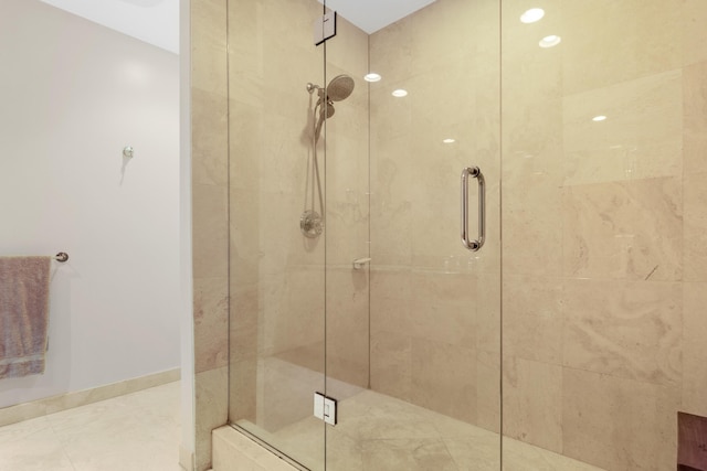 bathroom featuring a shower with door