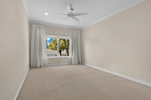 carpeted spare room with crown molding and ceiling fan