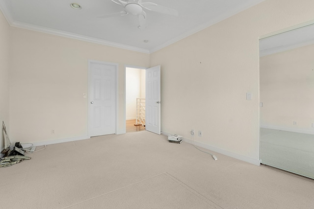 spare room with crown molding, carpet, and ceiling fan