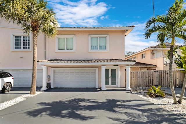 view of front of home with french doors and a garage