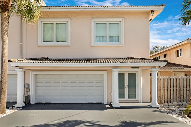 view of front of home with a garage and french doors