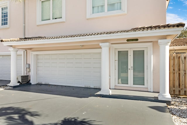 property entrance featuring a garage and french doors