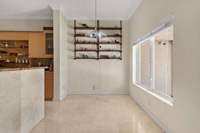 unfurnished dining area featuring ornamental molding and indoor bar