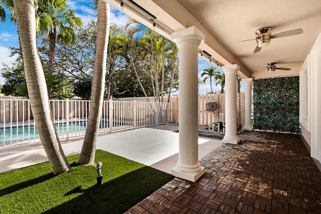 view of patio featuring a fenced in pool and ceiling fan