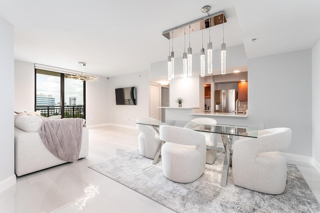 dining area featuring a wall of windows and sink