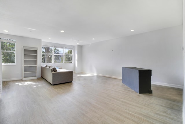 unfurnished living room with light hardwood / wood-style flooring and a wealth of natural light