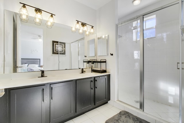 bathroom with ceiling fan, tile patterned flooring, vanity, and walk in shower