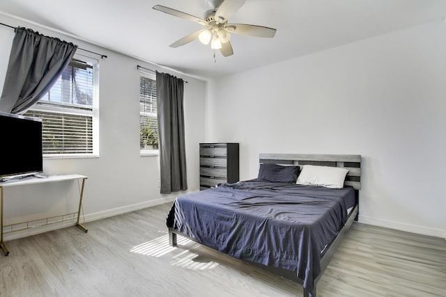 bedroom featuring ceiling fan and light hardwood / wood-style flooring