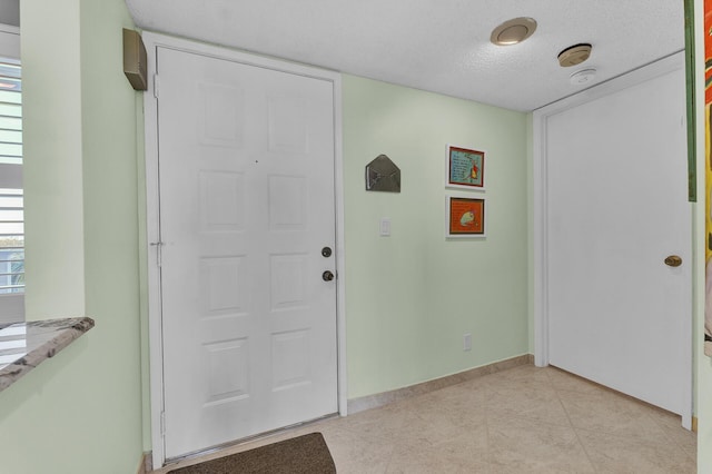 entrance foyer featuring a textured ceiling