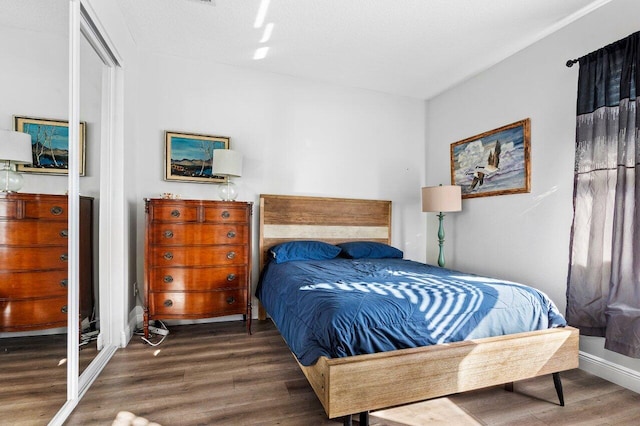 bedroom with dark wood-type flooring