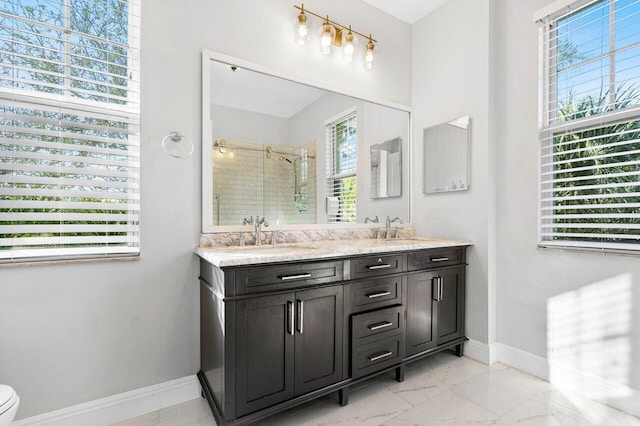 bathroom with vanity and a shower with door