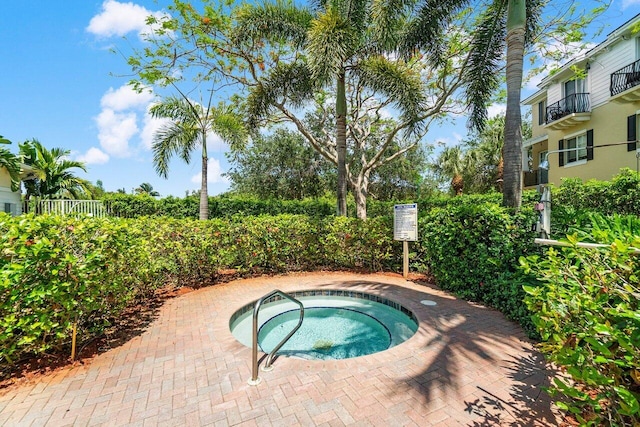 view of swimming pool with a hot tub