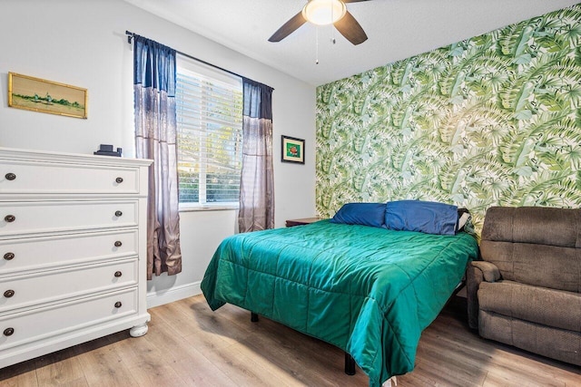 bedroom featuring multiple windows, ceiling fan, and light hardwood / wood-style floors