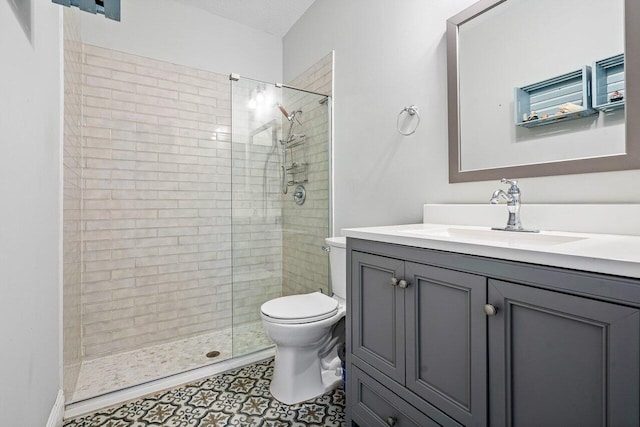 bathroom with tile patterned flooring, a textured ceiling, an enclosed shower, toilet, and vanity