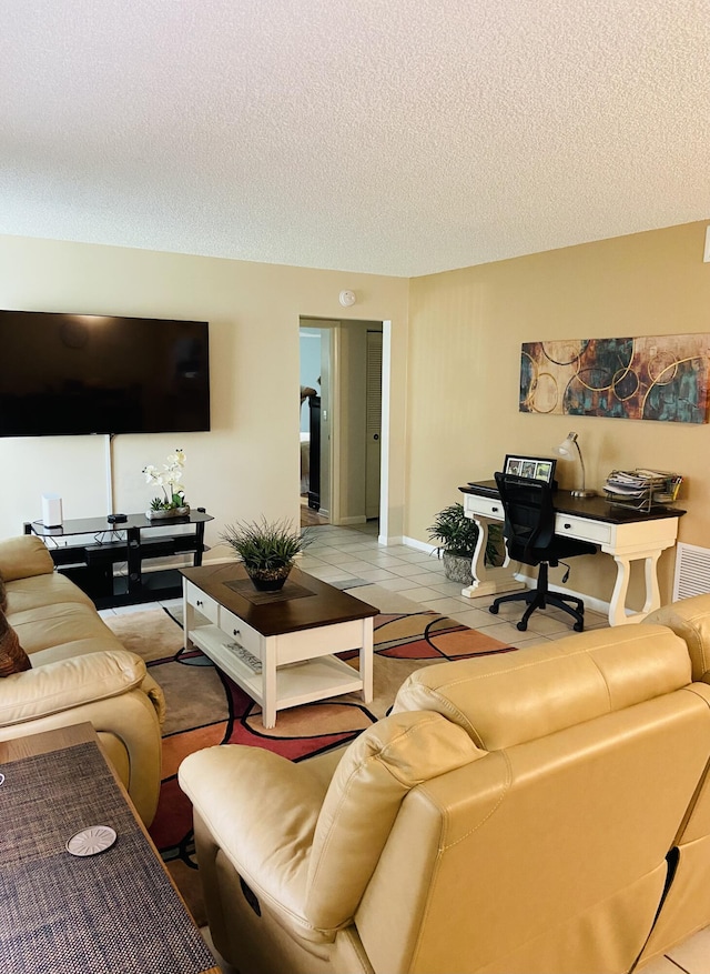 living room featuring a textured ceiling and light tile patterned flooring