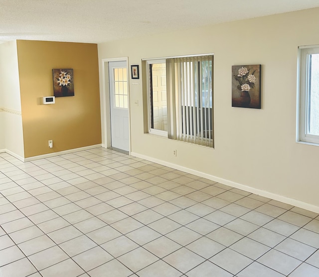 spare room with baseboards