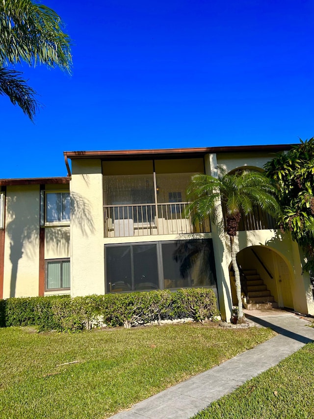 rear view of property with a lawn