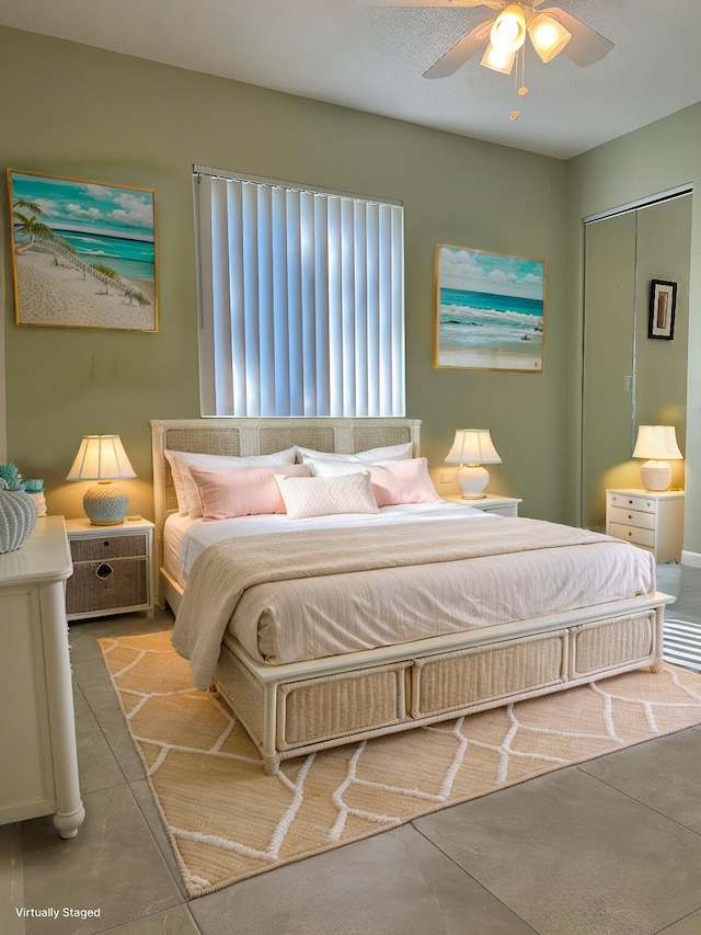 bedroom with a ceiling fan and concrete flooring