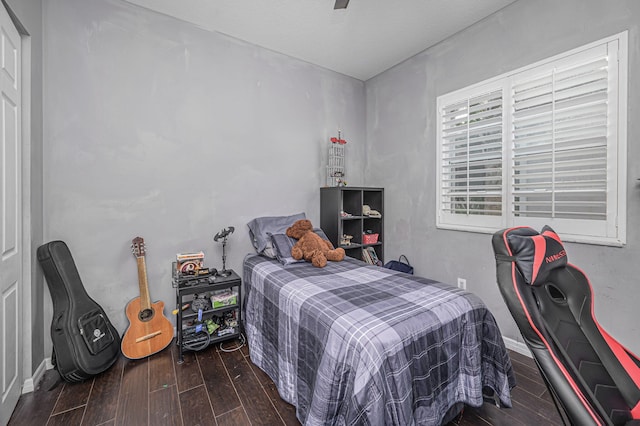 bedroom featuring ceiling fan and dark hardwood / wood-style flooring