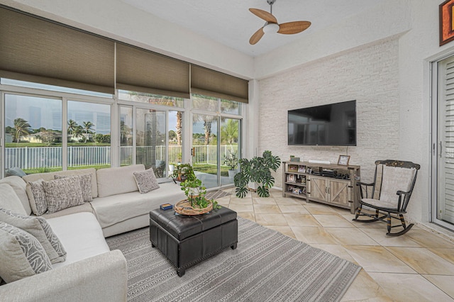 sunroom / solarium featuring ceiling fan