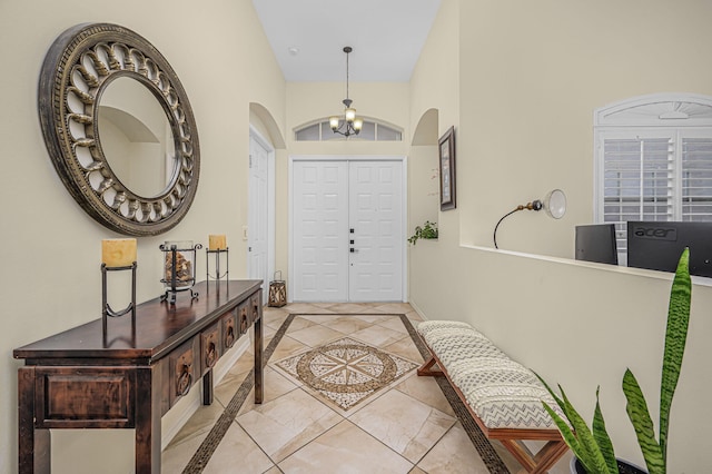 entryway with a chandelier