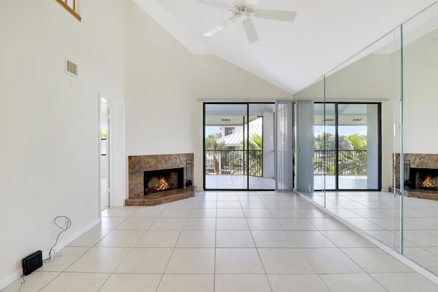 unfurnished living room with ceiling fan, light tile patterned floors, and a fireplace