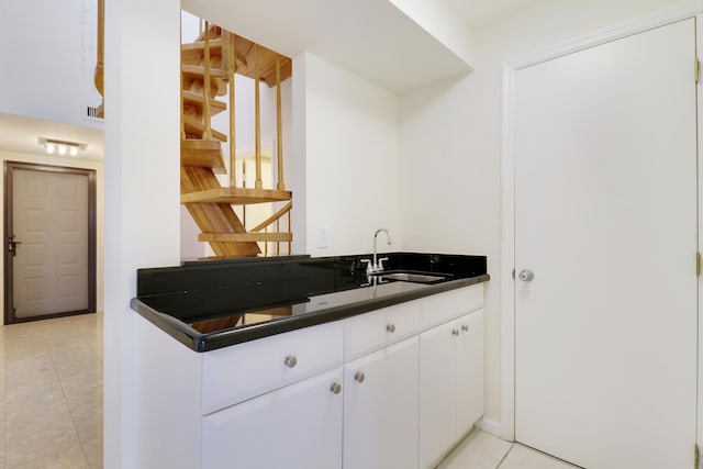 kitchen with white cabinetry and sink