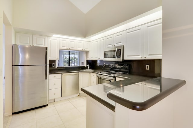 kitchen featuring white cabinetry, kitchen peninsula, stainless steel appliances, and light tile patterned floors