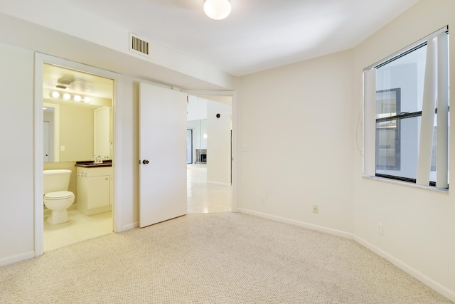 interior space featuring carpet flooring and connected bathroom