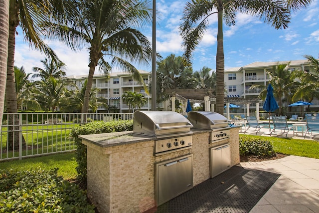 view of patio / terrace with a pergola, a grill, a community pool, and area for grilling