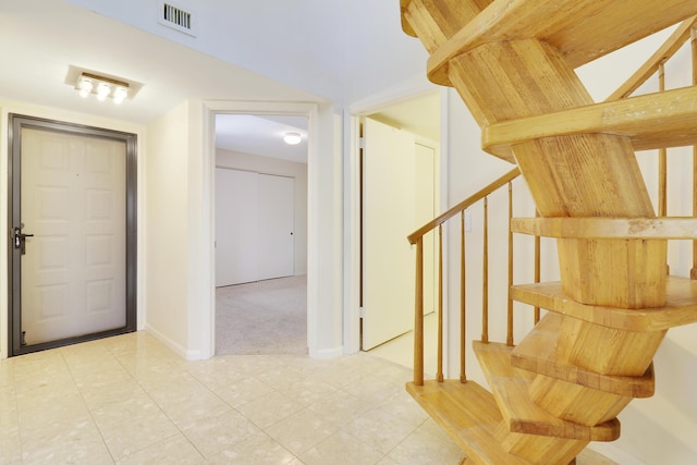 stairs featuring carpet floors