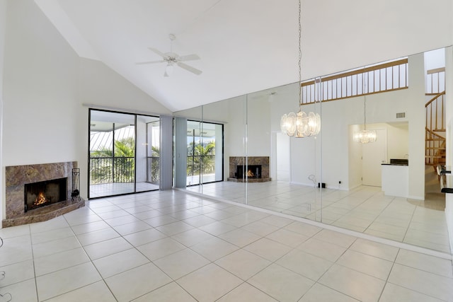 unfurnished living room featuring a fireplace, light tile patterned floors, and high vaulted ceiling