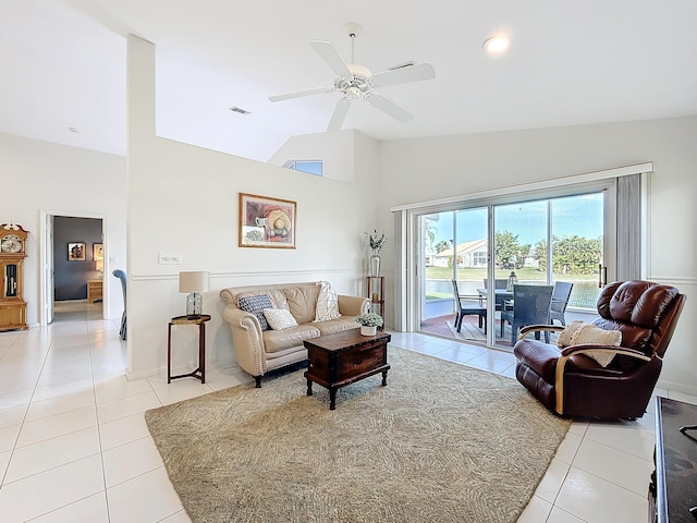 tiled living room with ceiling fan and vaulted ceiling