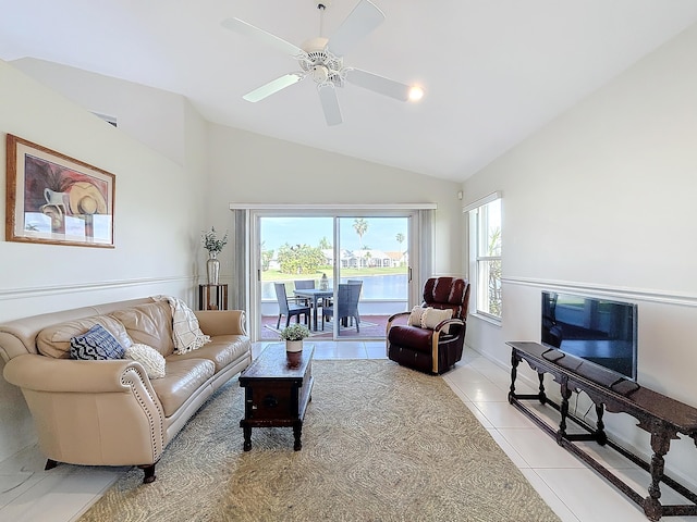 tiled living room with ceiling fan, a wealth of natural light, and vaulted ceiling