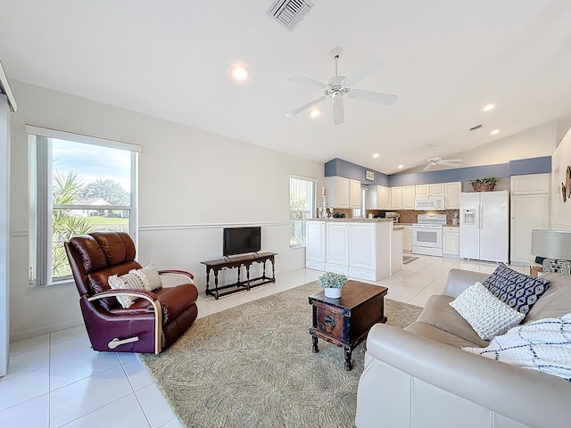 tiled living room with ceiling fan and vaulted ceiling