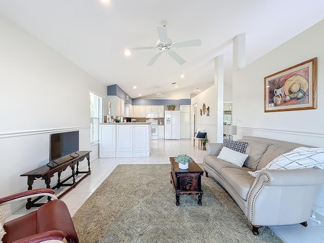 tiled living room with ceiling fan and lofted ceiling