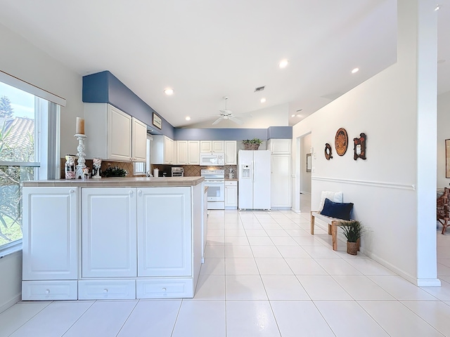 kitchen with decorative backsplash, white appliances, white cabinets, lofted ceiling, and light tile patterned flooring