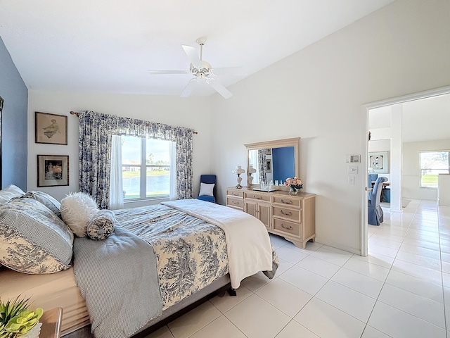 tiled bedroom featuring ceiling fan and vaulted ceiling